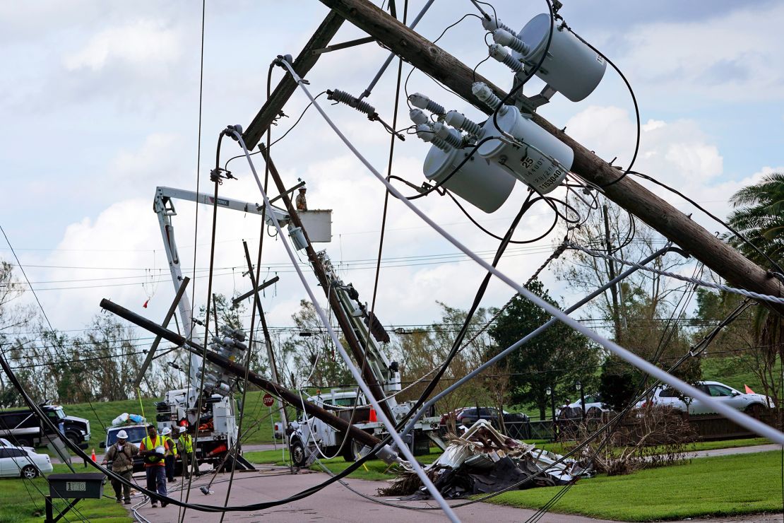 Crews begin work on downed power lines leading to a fire station on Tuesday in  Waggaman, Louisiana.