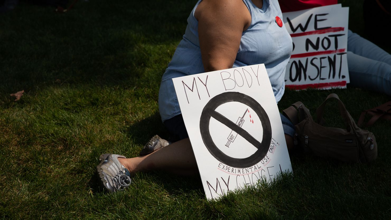 Demonstrators gather to protest mandated vaccines outside of the Michigan State Capitol on August 6, 2021, in Lansing, Michigan.
