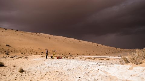 A storm arrives during archaeological excavation of an ancient lake.