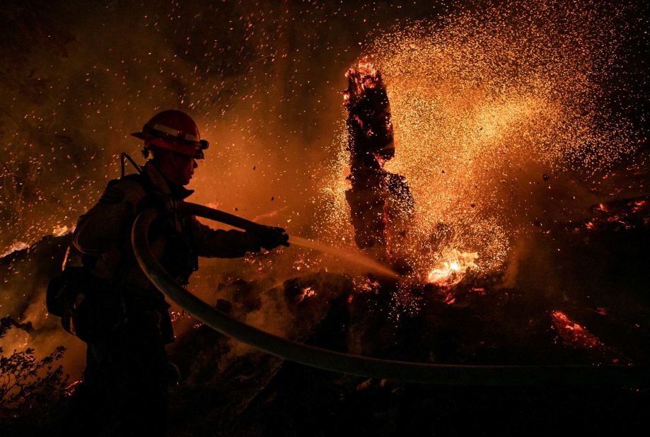 Jason Marone of the Roseville Fire Department hoses down a hot spot in Meyers, California, on August 31.