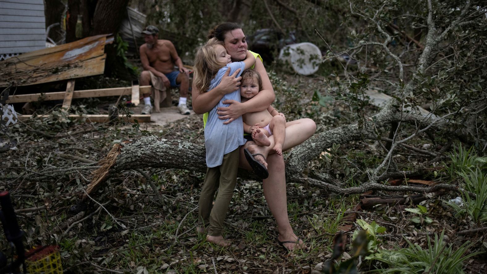 Tiffany Miller embraces her daughter Desilynn, left, and godchild Charleigh after the family returned to their destroyed home in Golden Meadow, Louisiana, on Wednesday, September 1.