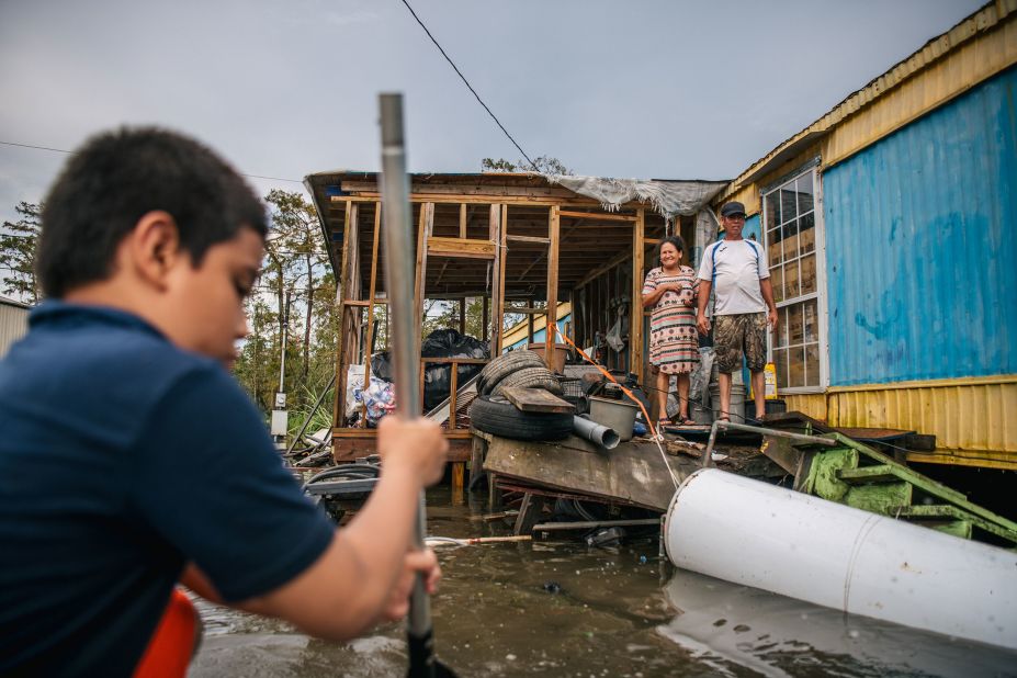 The Maldonado family stands outside their damaged home in Barataria, Louisiana, on August 31. "I've lost everything in my trailer because of the hurricane," said Fusto Maldonado when asked about the storm's impact. "I've lost everything, my family has lost everything, and we're now trying to find help. We all live in this area and now it's all gone."