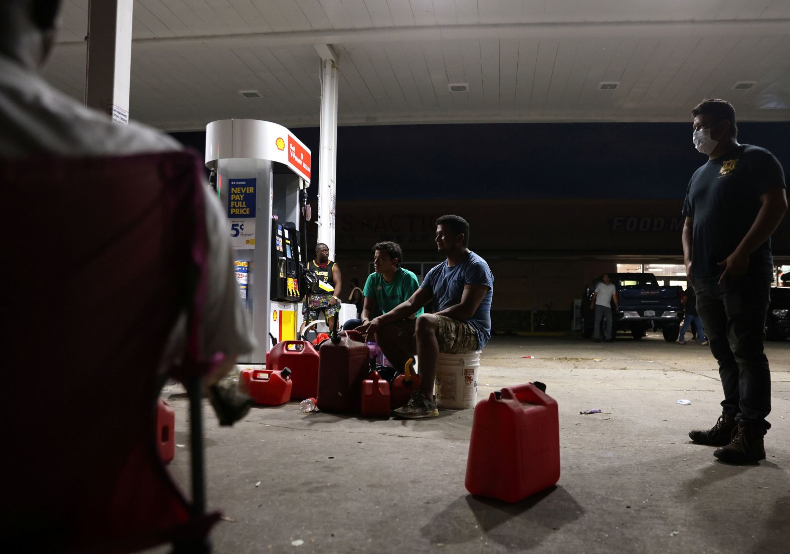 People wait for a gas truck to arrive at a gas station in New Orleans on August 31.