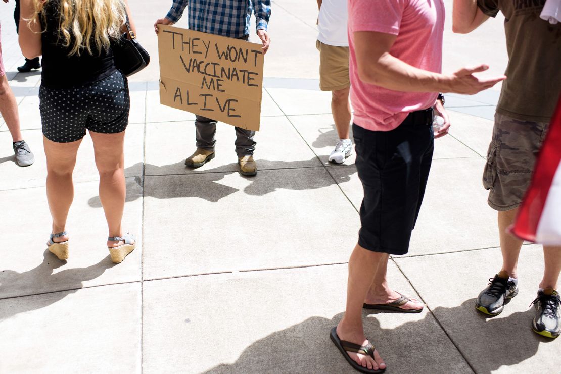 Anti-vaccine rally protesters hold signs outside of Houston Methodist Hospital in Houston, Texas, on June 26, 2021.