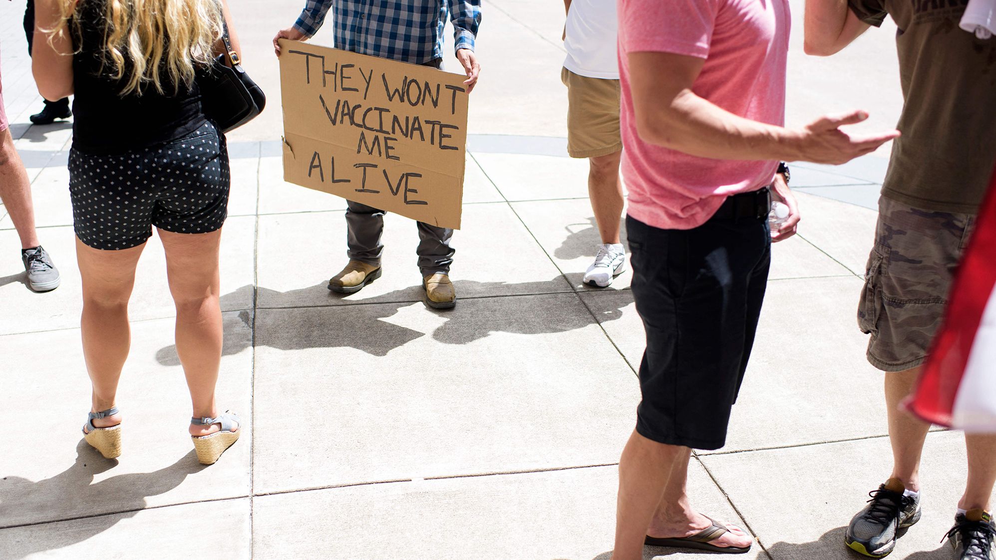 Anti-vaccine rally protesters hold signs outside of Houston Methodist Hospital in Houston, Texas, on June 26, 2021. 