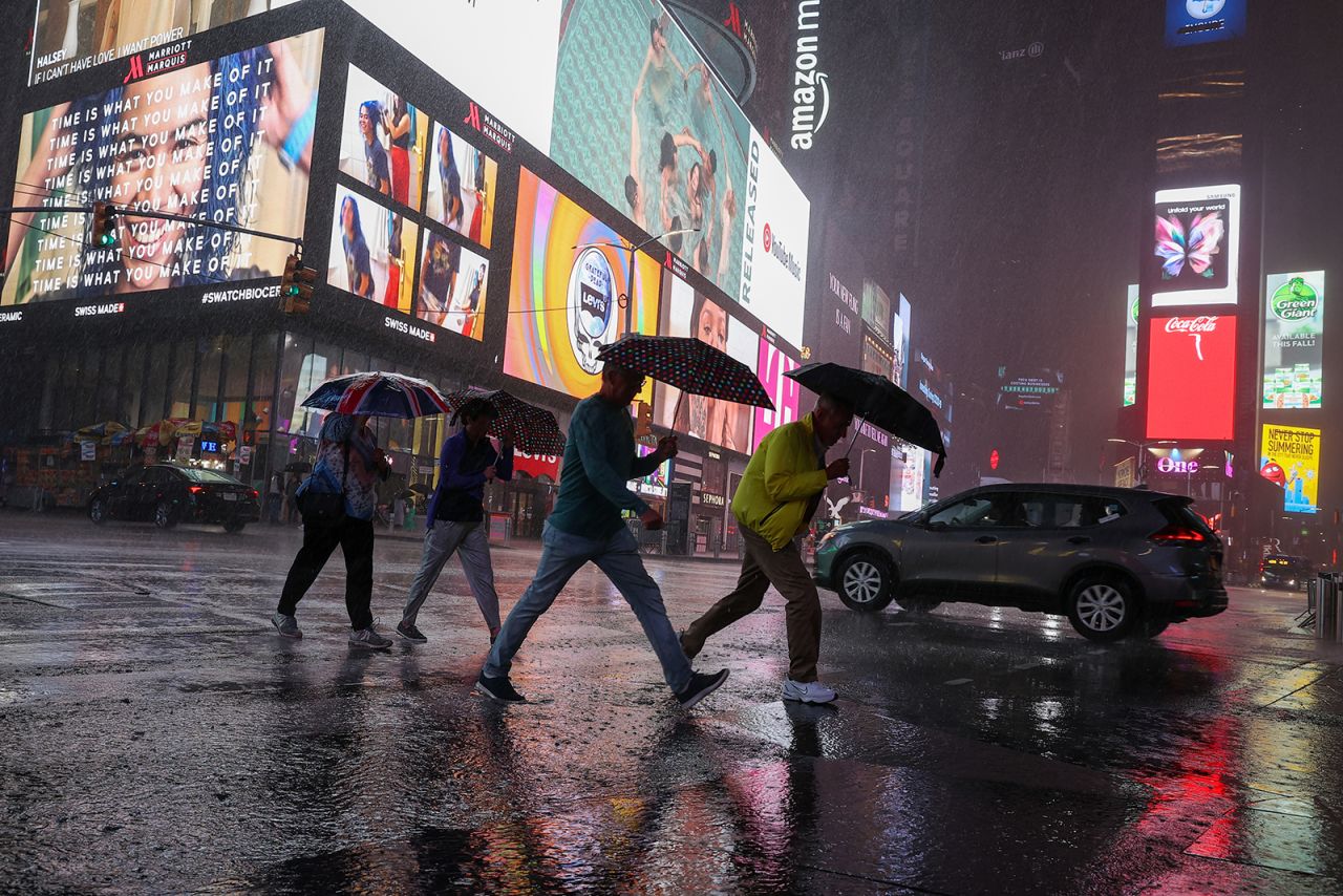 People walk through heavy rain in New York's Times Square on September 1.