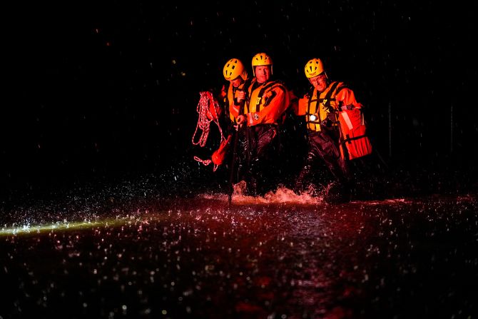 Members of the Weldon Fire Company walk through floodwaters in Dresher, Pennsylvania, on September 1.