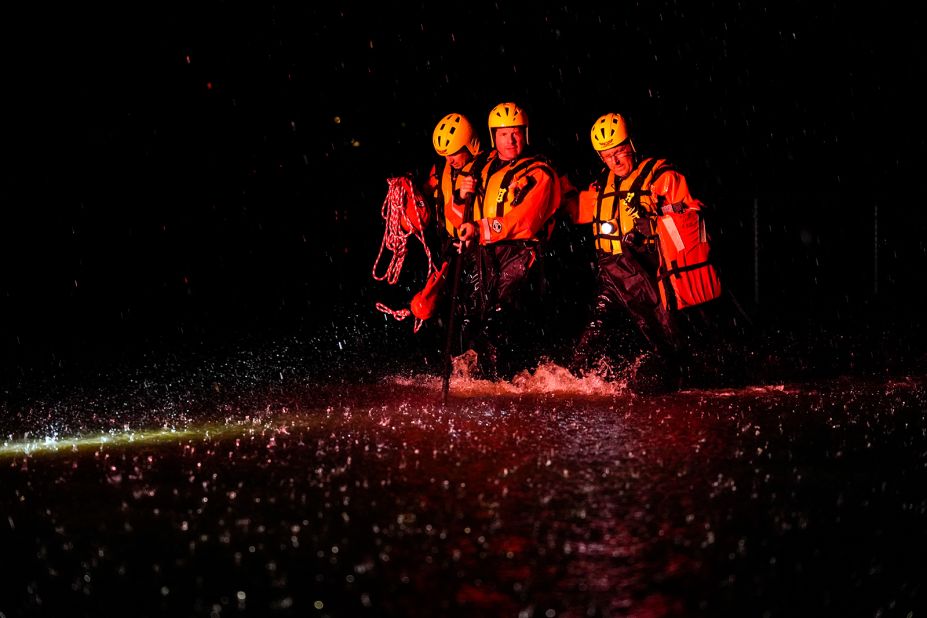 Members of the Weldon Fire Company walk through floodwaters in Dresher, Pennsylvania, on September 1.