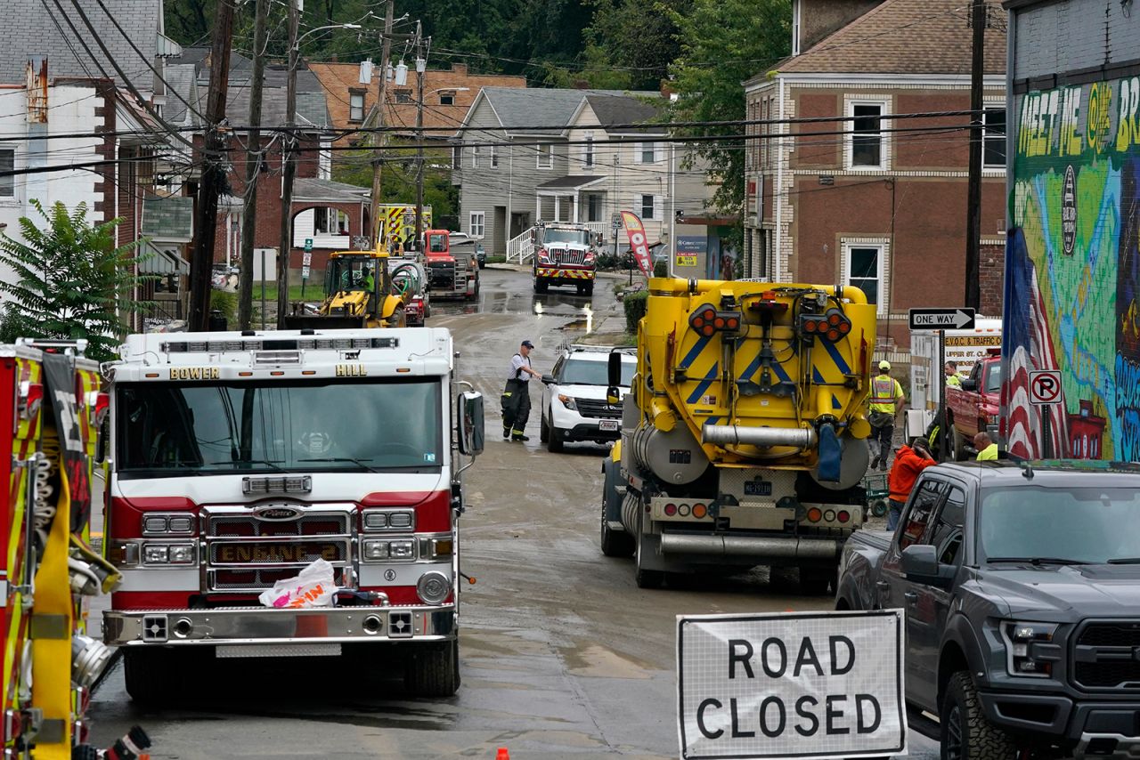 Workers clear a road from flooding in Bridgeville, Pennsylvania, on September 1.