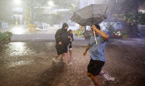 People navigate heavy rains and flooded walkways at the Billie Jean King National Tennis Center in New York City on September 1.