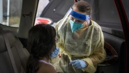 A health care worker administers a Covid-19 test to a child at the Austin Regional Clinic drive-thru vaccination and testing site in Austin, Texas on  August 5, 2021.