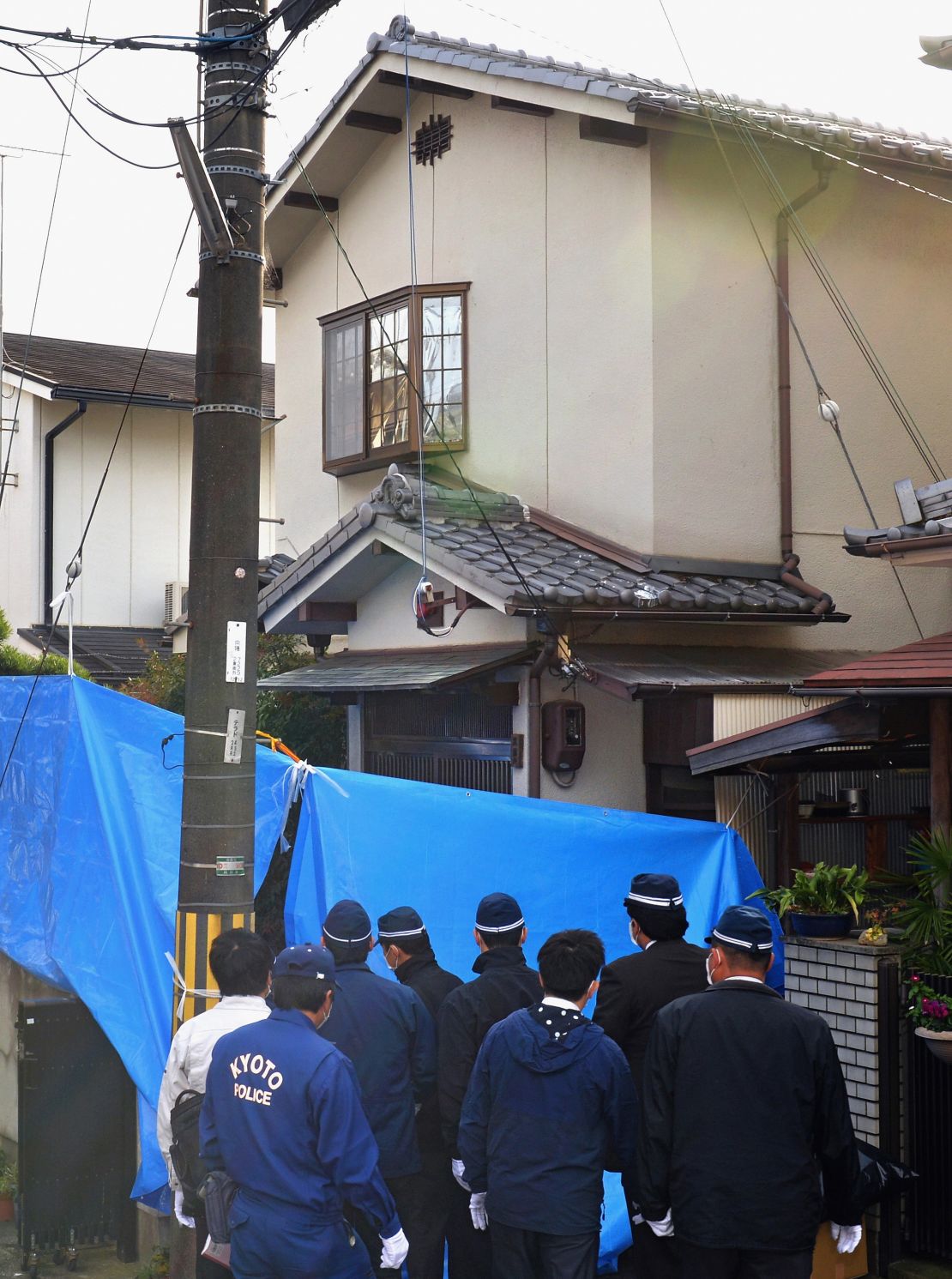 Investigators search the home of Chisako Kakehi and her deceased husband Isao on November 20, 2014, in Muko, Japan.
