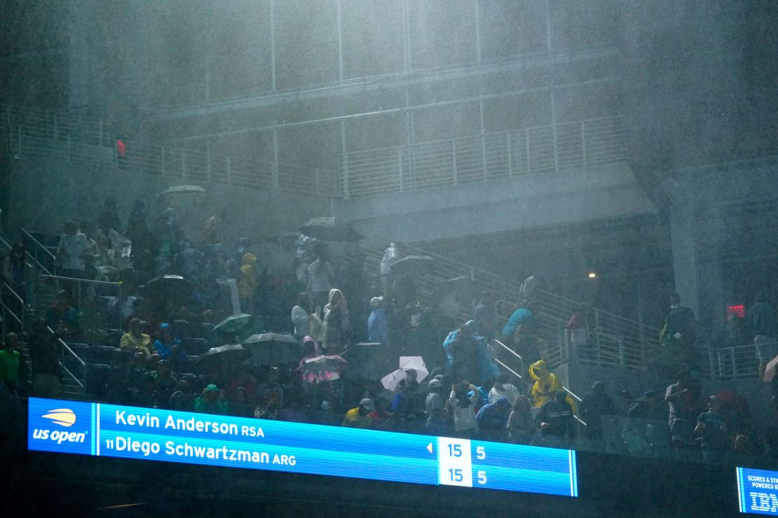 Rain falls into Louis Armstrong Stadium during the second-round match between Diego Schwartzman and Kevin Anderson.