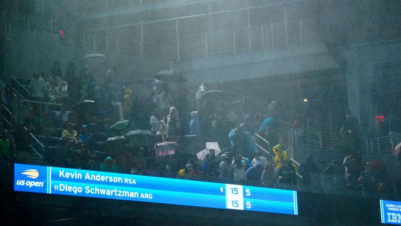 Rain falls into Louis Armstrong Stadium during the second-round match between Diego Schwartzman and Kevin Anderson.