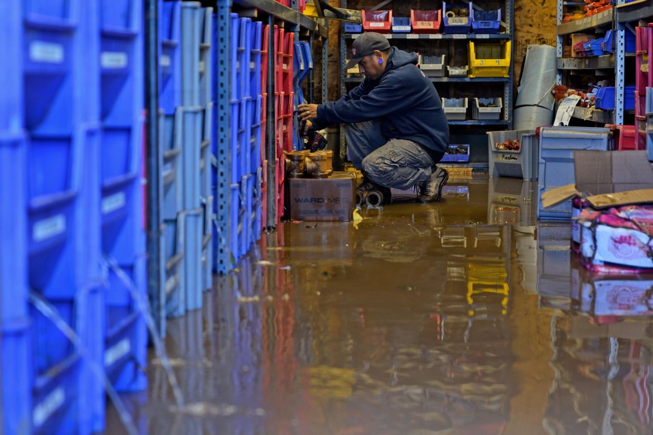 A United Automatic Fire Sprinkler employee helps clean up on September 2 after the business flooded in Woodland Park, New Jersey.