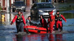 First responders pull local residents in a boat as they perform rescues of people trapped by floodwaters after the remnants of Tropical Storm Ida brought drenching rain,  flash floods and tornadoes to parts of the northeast in Mamaroneck, New York, U.S., September 2, 2021. REUTERS/Mike Segar