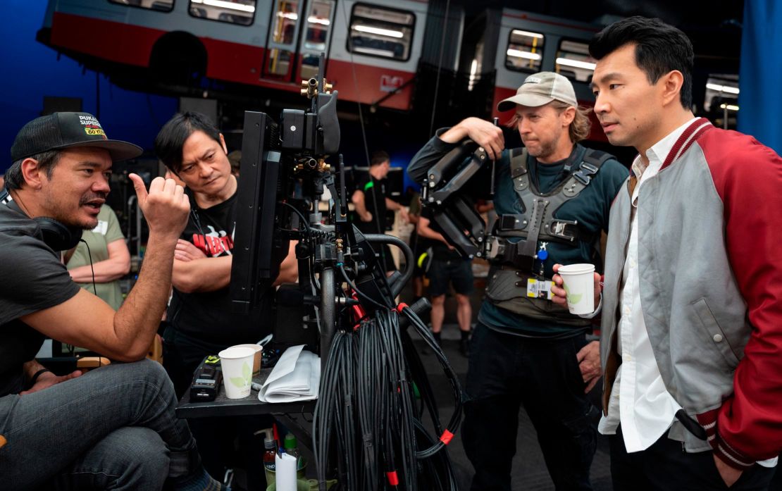 Director Destin Daniel Cretton, fight coordinator Andy Cheng, crew camera operator and actor Simu Liu on set.