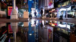 The lights of Times Square in New York are reflected in standing water Thursday, September 2, 2021, as Hurricane Ida left behind not just water on city streets but wind damage and severe flooding along the Eastern seaboard. 