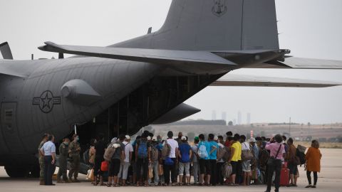 Afghan refugees at an airbase in Madrid, Spain,  board a US aircraft heading to Germany after being evacuated from Kabul on August 24, 2021. 