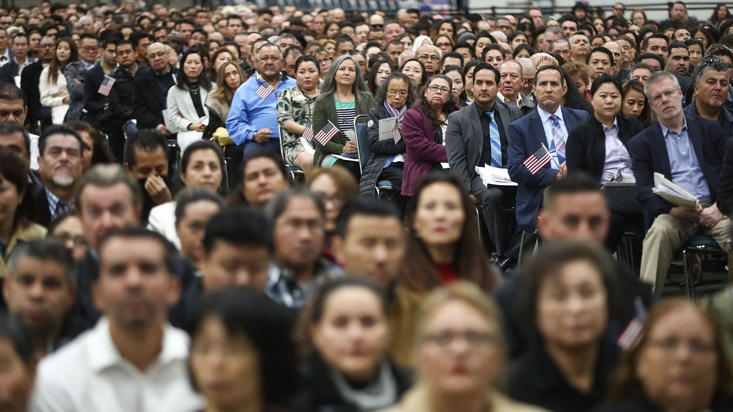 New US citizens gather at a naturalization ceremony on March 20, 2018, in Los Angeles. The  ceremony welcomed more than 7,200 immigrants from over 100 countries who took the citizenship oath and pledged allegiance to the American flag.