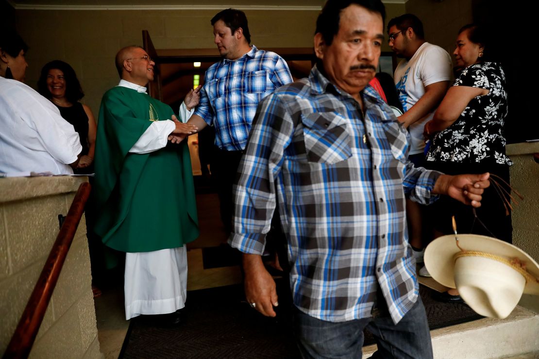 A priest greets worshippers after leading a Spanish-spoken church service in West Liberty, Iowa, on August 25, 2019. 