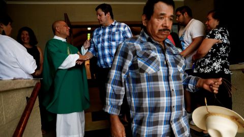 A priest greets worshippers after leading a Spanish-spoken church service in West Liberty, Iowa, on August 25, 2019.