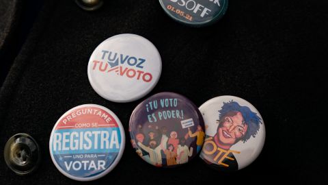 An attendee wears Spanish-language buttons during a campaign event for Democratic Senate candidate Jon Ossoff in Lilburn, Georgia, on December 7, 2020.