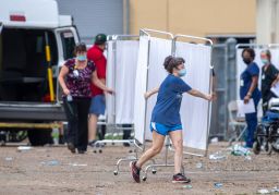 Emergency personnel evacuate people at a mass shelter Thursday in Independence, Louisiana.