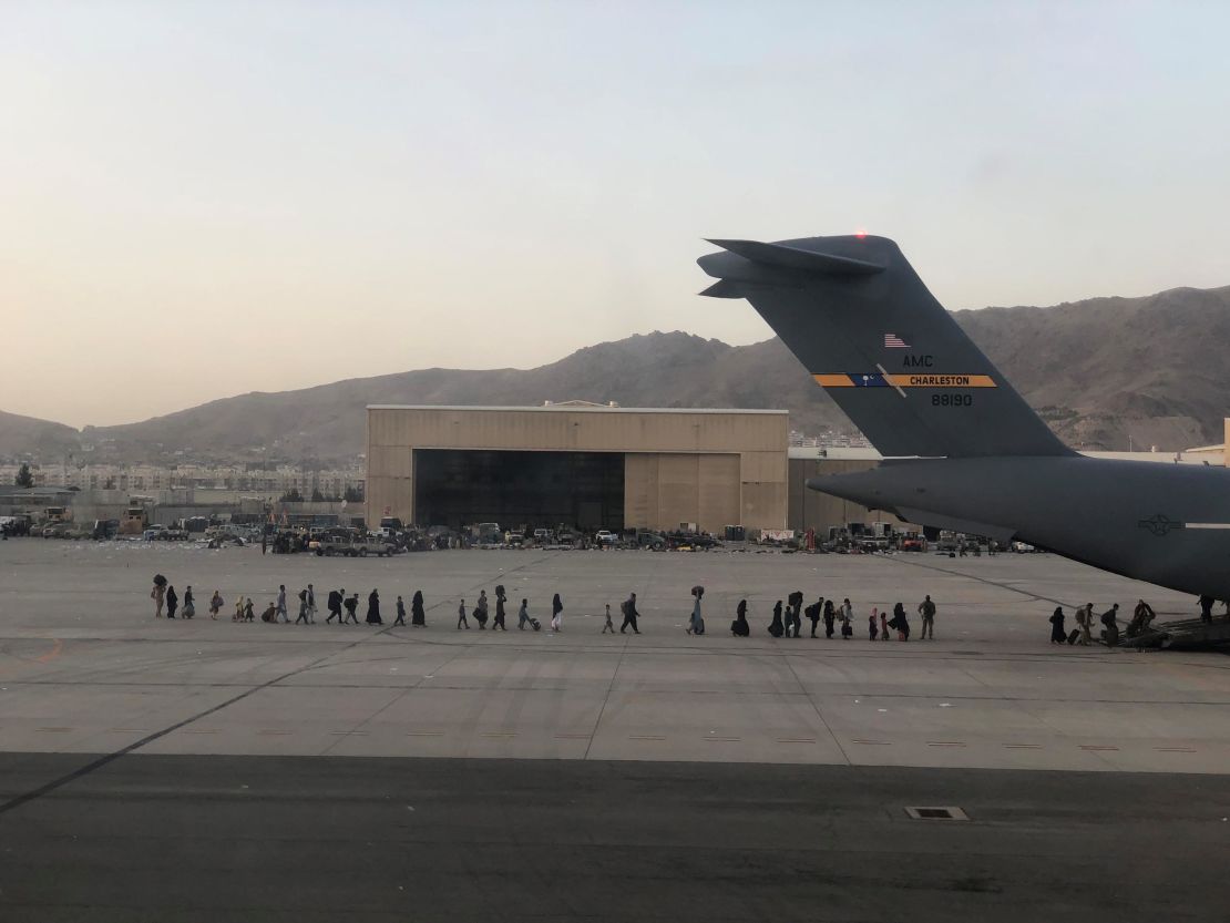 Afghan evacuees board a C-17 at Hamid Karzai International Airport in Kabul, Afghanistan.