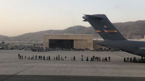 Afghan evacuees board a C-17 at Hamid Karzai International Airport in Kabul, Afghanistan.