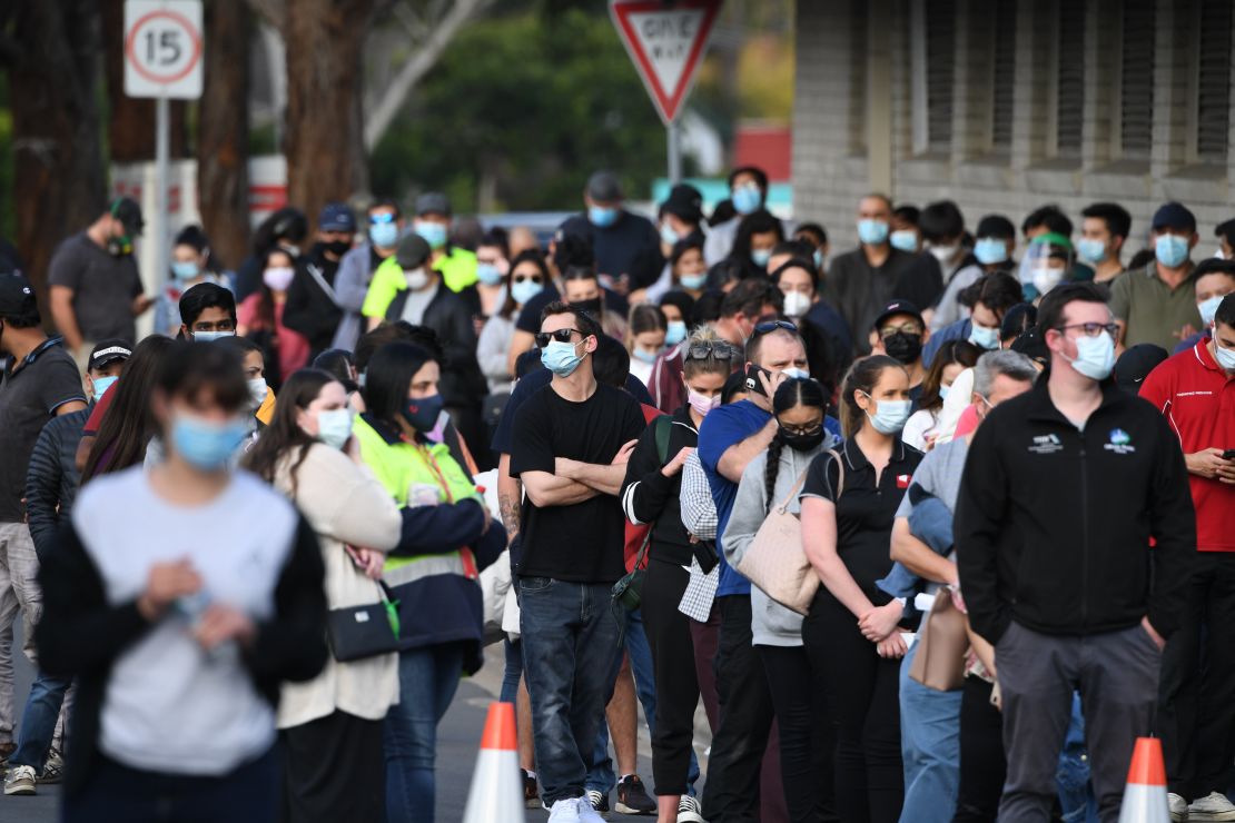 Hundreds of people wait in line for their Covid-19 vaccine at the South Western Sydney vaccination centre at Macquarie Fields on August 19 in Sydney, Australia.