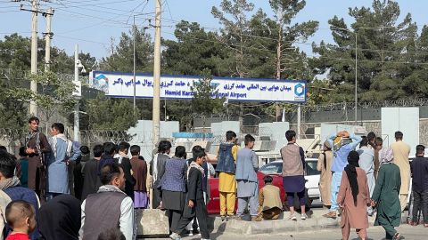 Afghans wait around the Kabul international airport as they try to flee the Afghan capital on August 20, 2021.