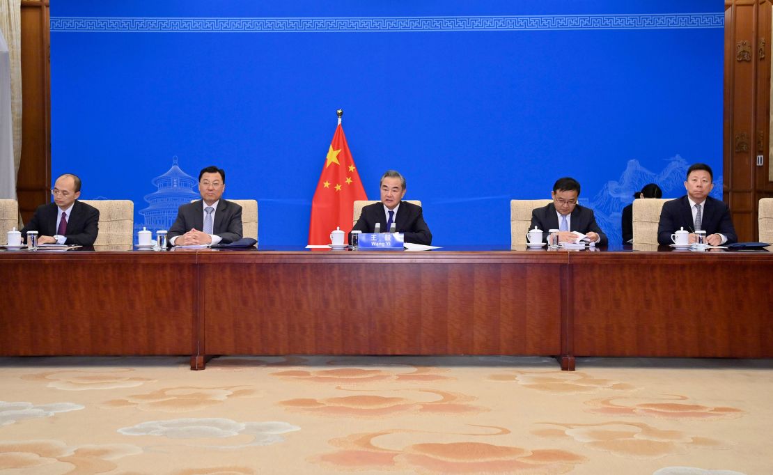 Chinese Foreign Minister Wang Yi, center, and other officials meeting with Kerry via videolink on Wednesday.