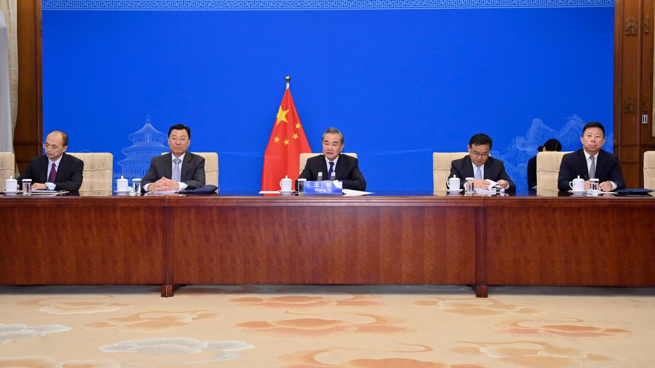 Chinese Foreign Minister Wang Yi, center, and other officials meeting with Kerry via videolink on Wednesday.
