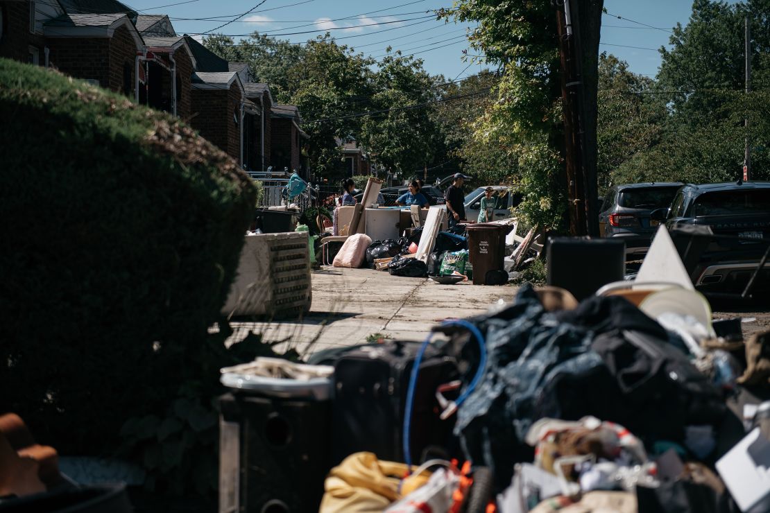 Residents sort through damaged and destroyed items in the Flushing neighborhood of the Queens borough of New York City. 