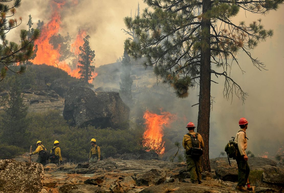 Firefighters try to control a back fire to help battle the Caldor Fire near Lake Tahoe on September 2, 2021.