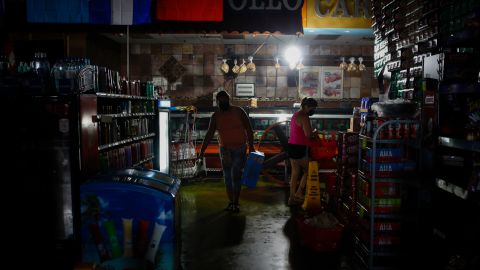 Shoppers buy supplies at a grocery store during the blackout after Hurricane Ida in New Orleans, Louisiana.
