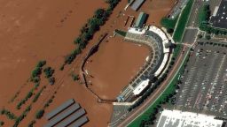 In a satellite image provided by Maxar Technologies, the stadium for the Somerset Patriots Double-A baseball team is partially flooded by overflow from the Raritan River on Thursday, Sept. 2, 2021, in Bridgewater Township, N.J., the day after torrential rain from the remnants of Hurricane Ida drenched the area. A railroad line to the left of the stadium is submerged. (Maxar Technologies via AP)
