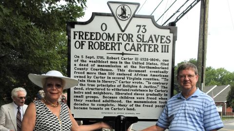 The Northern Neck of Virginia Historical Society has been honoring those manumitted by Carter since 2008. A highlight of the 2016 ceremony was the unveiling of a highway marker, which the society secured funding for. Here, Regina Baylor, a descendant of nine WIlson family members who Carter freed, and Carter descendant Charles Belfield pose with the sign. 
