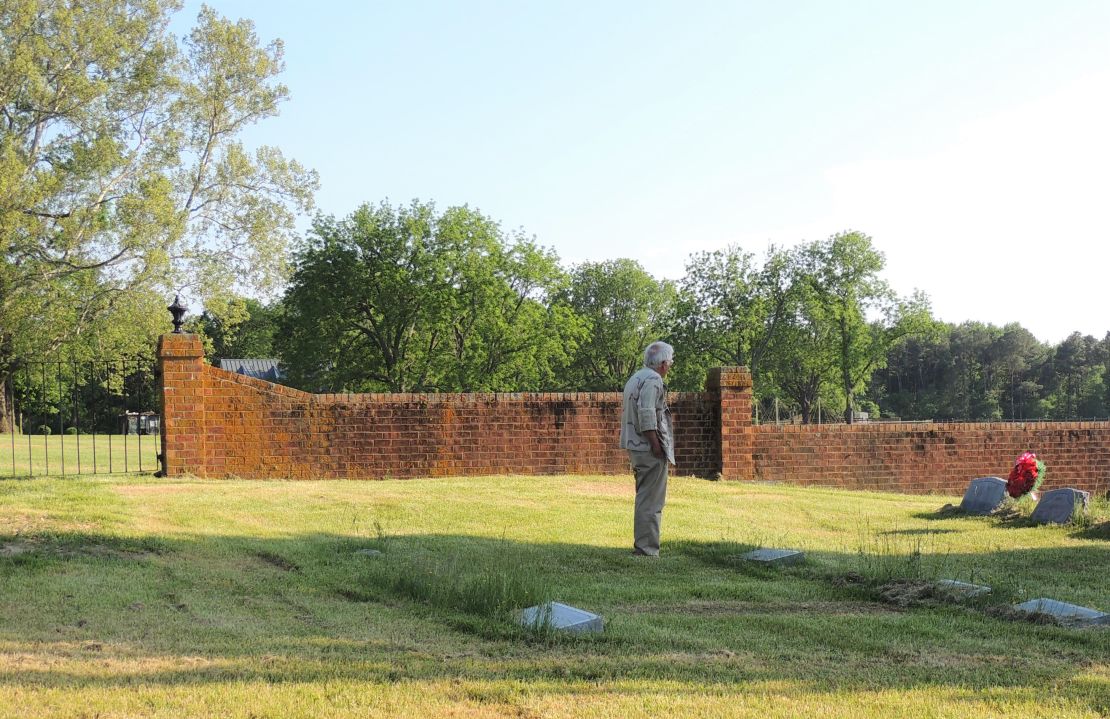 Bicentennial organizer Frank Delano examines the Carter family cemetery at Nomini Hall in 2014. 