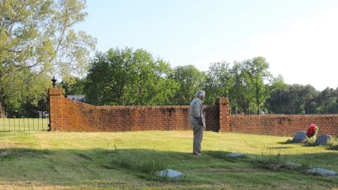 Bicentennial organizer Frank Delano examines the Carter family cemetery at Nomini Hall in 2014. 