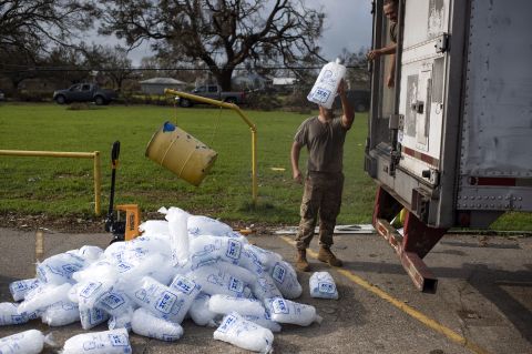 National Guard members unload ice at a distribution center in Montegut, Louisiana, on Thursday.