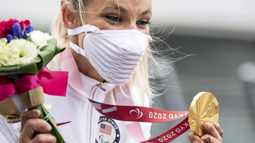 Gold medallist Oksana Masters of the US celebrates on the podium after competing in the women's cycling road individual H4-5 time trial during the Tokyo 2020 Paralympic Games at the Fuji International Speedway in Oyama on August 31, 2021. (Photo by CHARLY TRIBALLEAU / AFP) / The erroneous mention[s] appearing in the metadata of this photo by CHARLY TRIBALLEAU has been modified in AFP systems in the following manner: [August 31] instead of [August 30]. Please immediately remove the erroneous mention[s] from all your online services and delete it (them) from your servers. If you have been authorized by AFP to distribute it (them) to third parties, please ensure that the same actions are carried out by them. Failure to promptly comply with these instructions will entail liability on your part for any continued or post notification usage. Therefore we thank you very much for all your attention and prompt action. We are sorry for the inconvenience this notification may cause and remain at your disposal for any further information you may require. (Photo by CHARLY TRIBALLEAU/AFP via Getty Images)