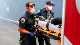 Paramedics Cody Miller, left, and Justin Jones respond to a heat exposure call during a heat wave, Saturday, June 26, 2021, in Salem, Ore. (AP Photo/Nathan Howard)