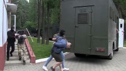 FILE In this file photo taken from video released by Belarusian KGB, State TV and Radio Company of Belarus on Wednesday, July 29, 2020, Belarusian KGB officers detain Russian men in a sanitarium outside in Minsk, Belarus. In what the opposition and many independent observers saw as Lukashenko's attempt to shore up sagging public support, Belarusian authorities arrested 33 Russian military contractors and charged them with plans to stage "mass riots.  Belarus' authoritarian President Alexander  Lukashenko faces a perfect storm as he seeks a sixth term in the election held Sunday, Aug. 9, 2020 after 26 years in office. (Belarusian KGB, State TV and Radio Company of Belarus via AP, File)