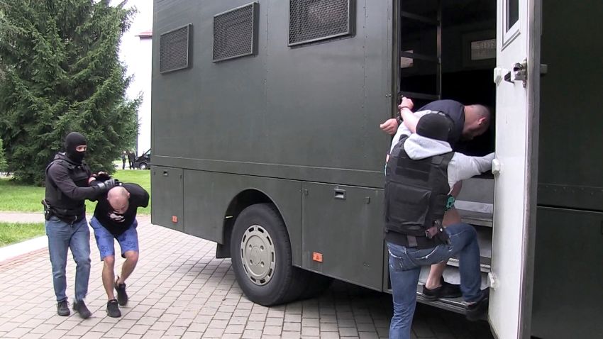 In this photo taken from video released by Belarusian KGB, State TV and Radio Company of Belarus on Wednesday, July 29, 2020, Belarusian KGB officers detain Russian men in a sanitarium outside in Minsk, Belarus. Belarusian officials said that more than 30 detained employees of private Russian military contractor Wagner are facing a criminal probe on charges of plotting terror attacks in Belarus amid a presidential election campaign. (Belarusian KGB, State TV and Radio Company of Belarus via AP)