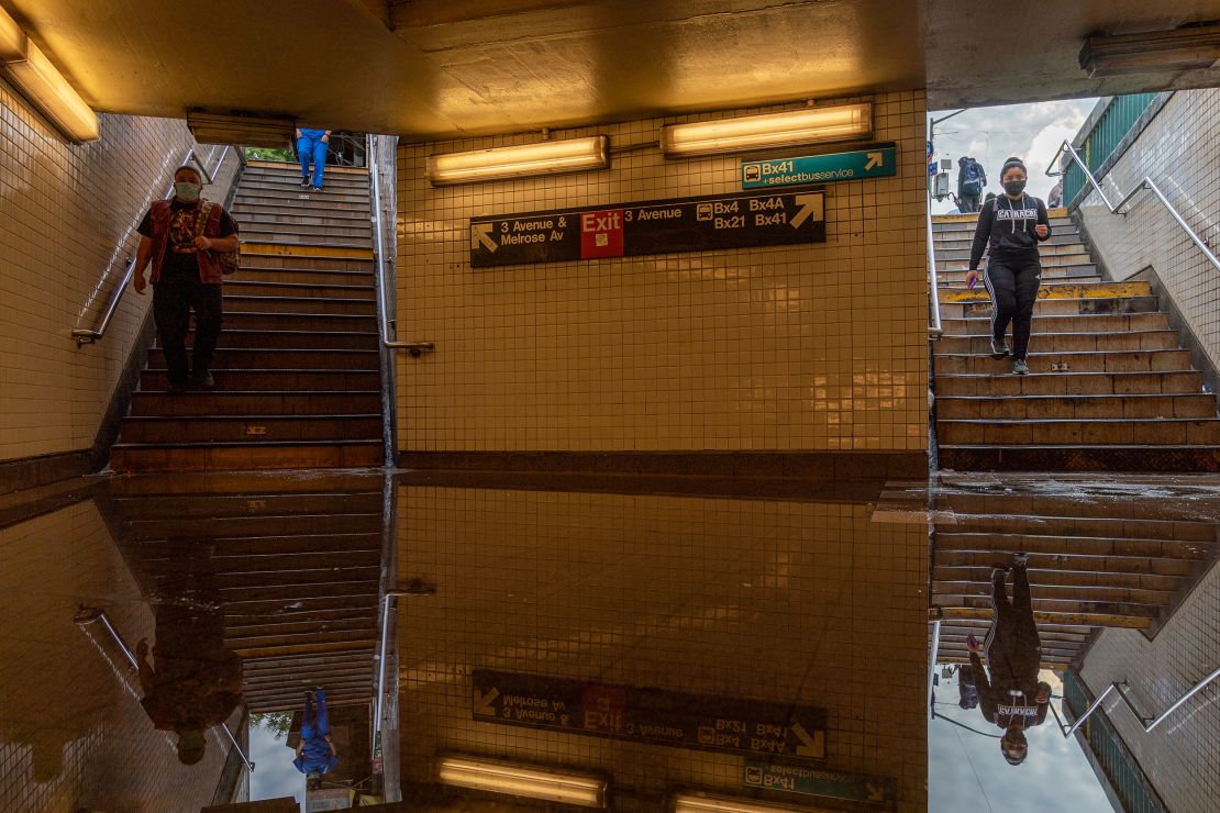 People walk into a flooded subway station in New York City. Heavy rainfall from the remnants of Hurricane Ida disrupted service, dumping more than 3 inches of rain in the span of an hour.