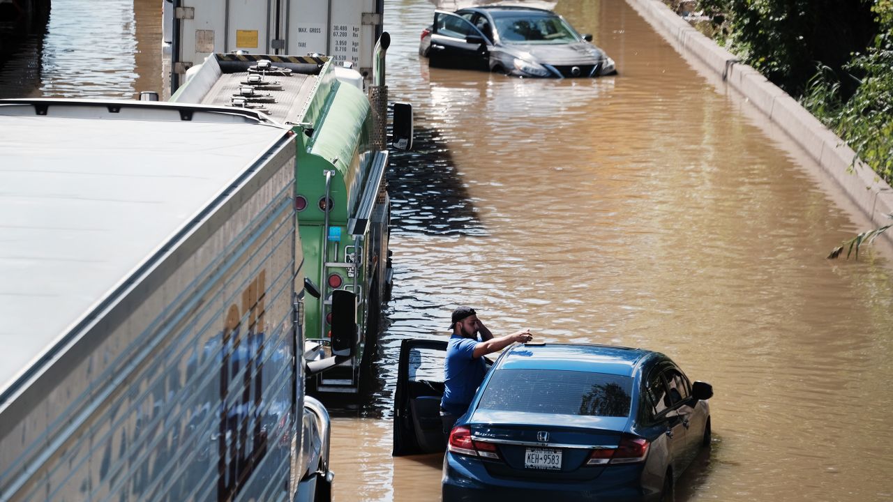 Cars sit abandoned on the flooded Major Deegan Expressway in the Bronx, New York, following a night of heavy wind and rain from the remnants of Hurricane Ida.