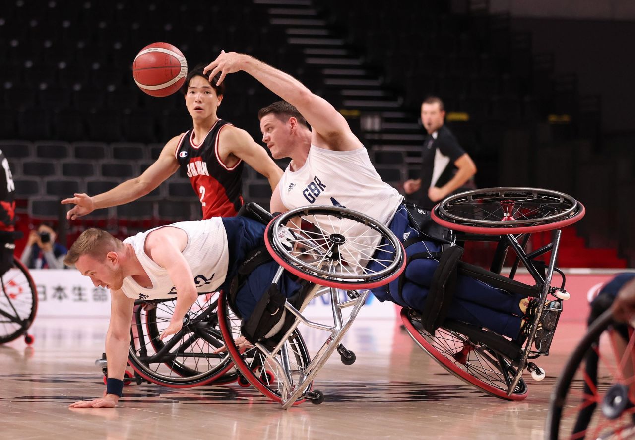Great Britain's Lee Manning, right, passes the ball as he collides with teammate Gregg Warburton during a wheelchair basketball game against Japan on September 3.