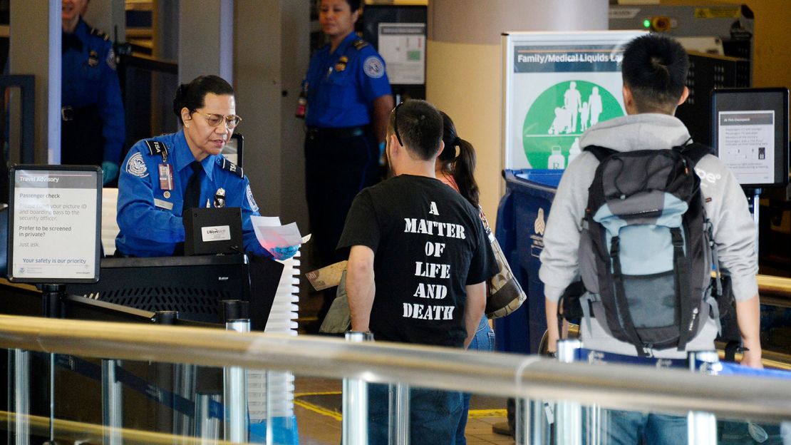 Boarding passes are checked at Los Angeles International Airport the day after gunman Paul Ciancia shot his way through security in November 2013. 